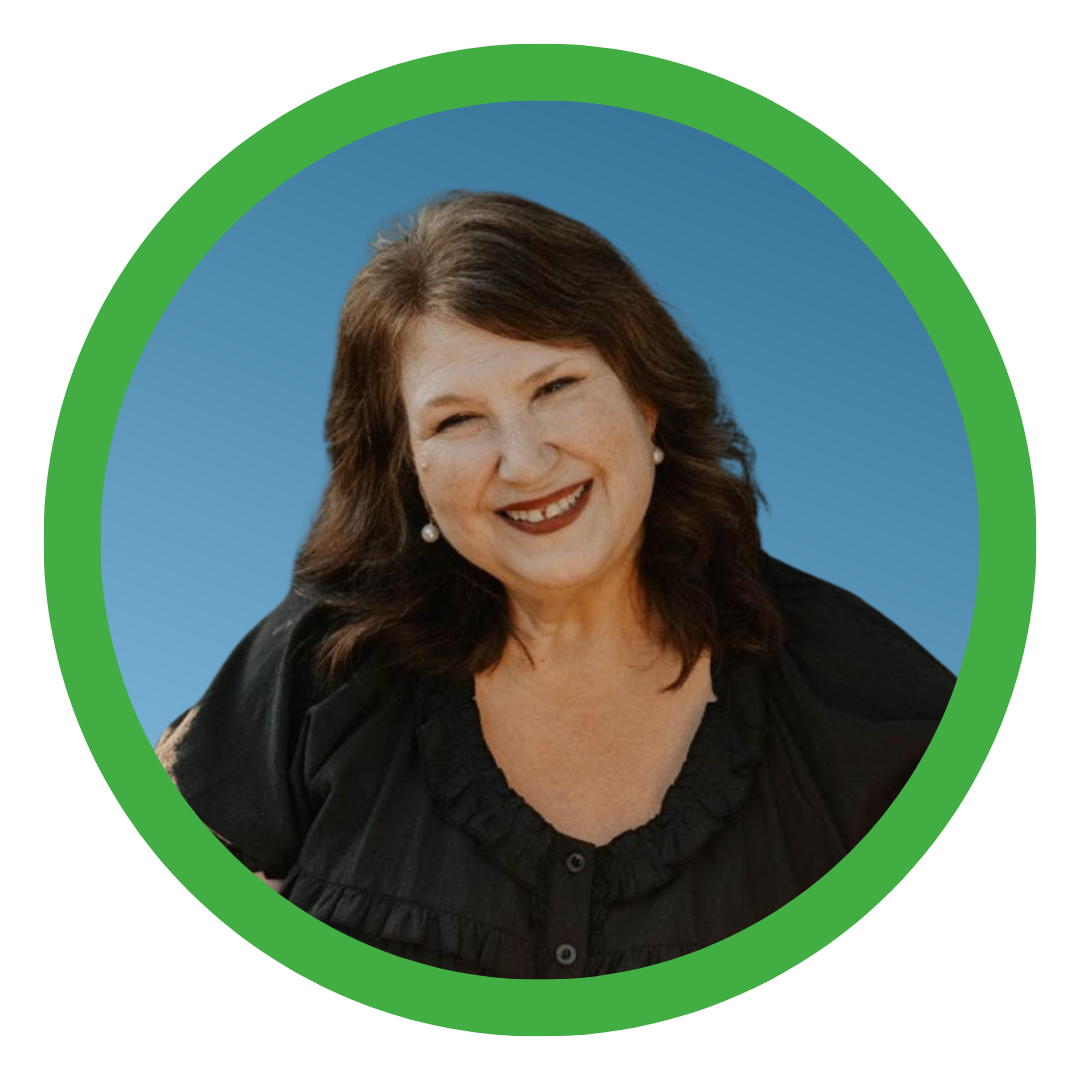 headshot of Jeane Burgess in a black blouse on a blue background with a green circle frame